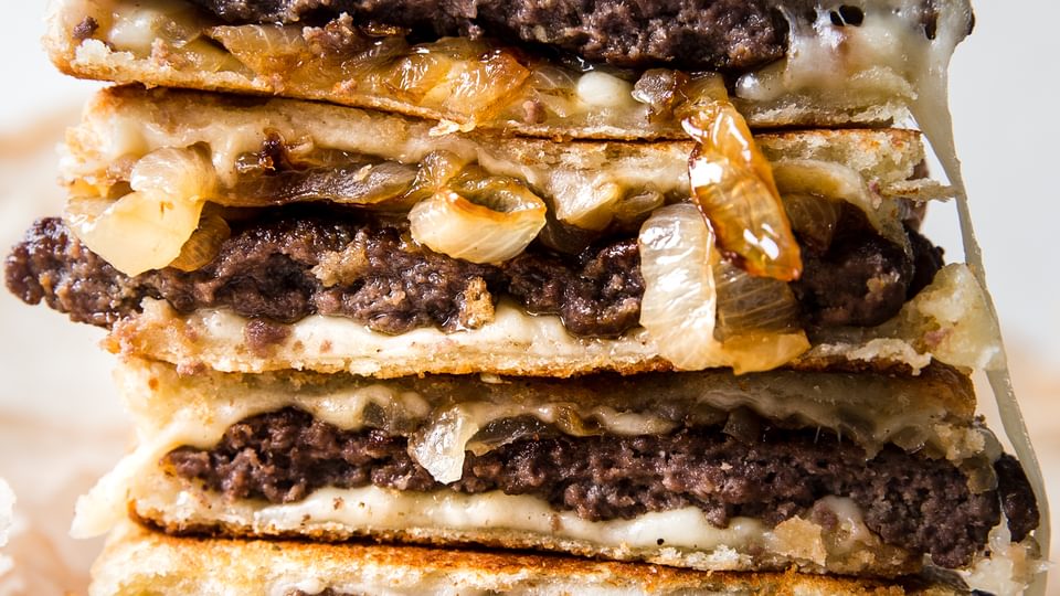 Patty Melt stack with grilled onions and swiss cheese