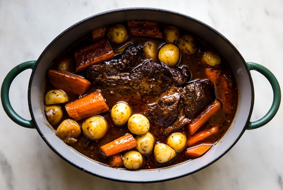 cooked pot roast in a Dutch oven ready to serve