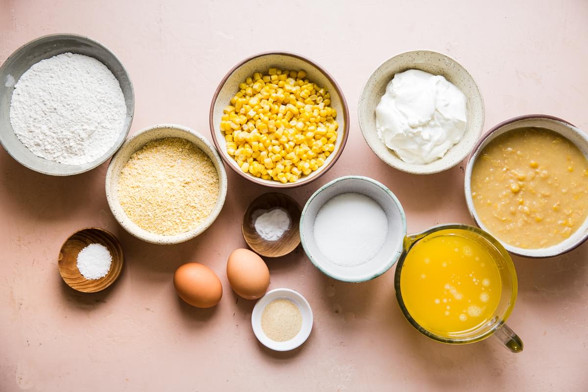 flour, corn meal, sweet canned corn, creamed corn, eggs, salt and sour cream in prep bowls to make spoon bread