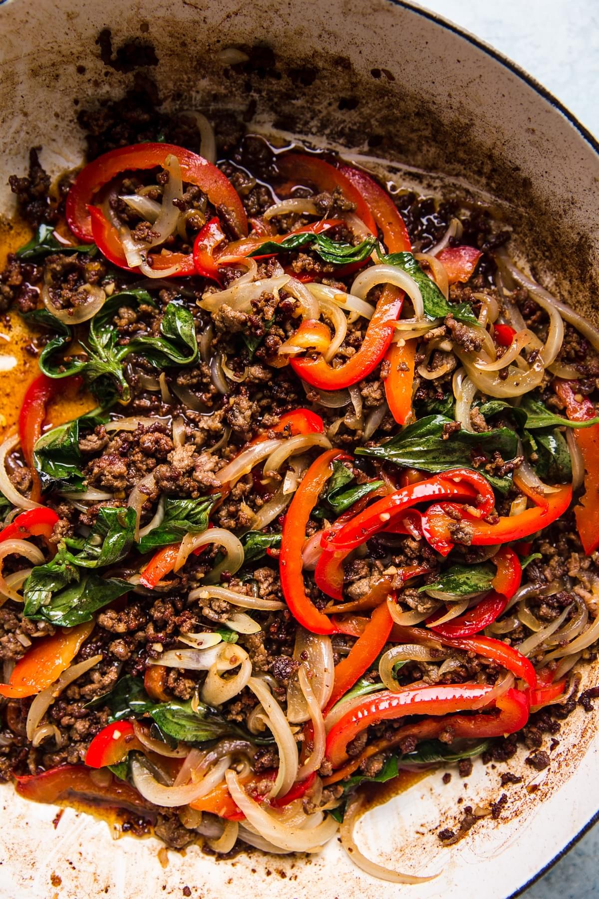 Thai basil beef in a large white skillet