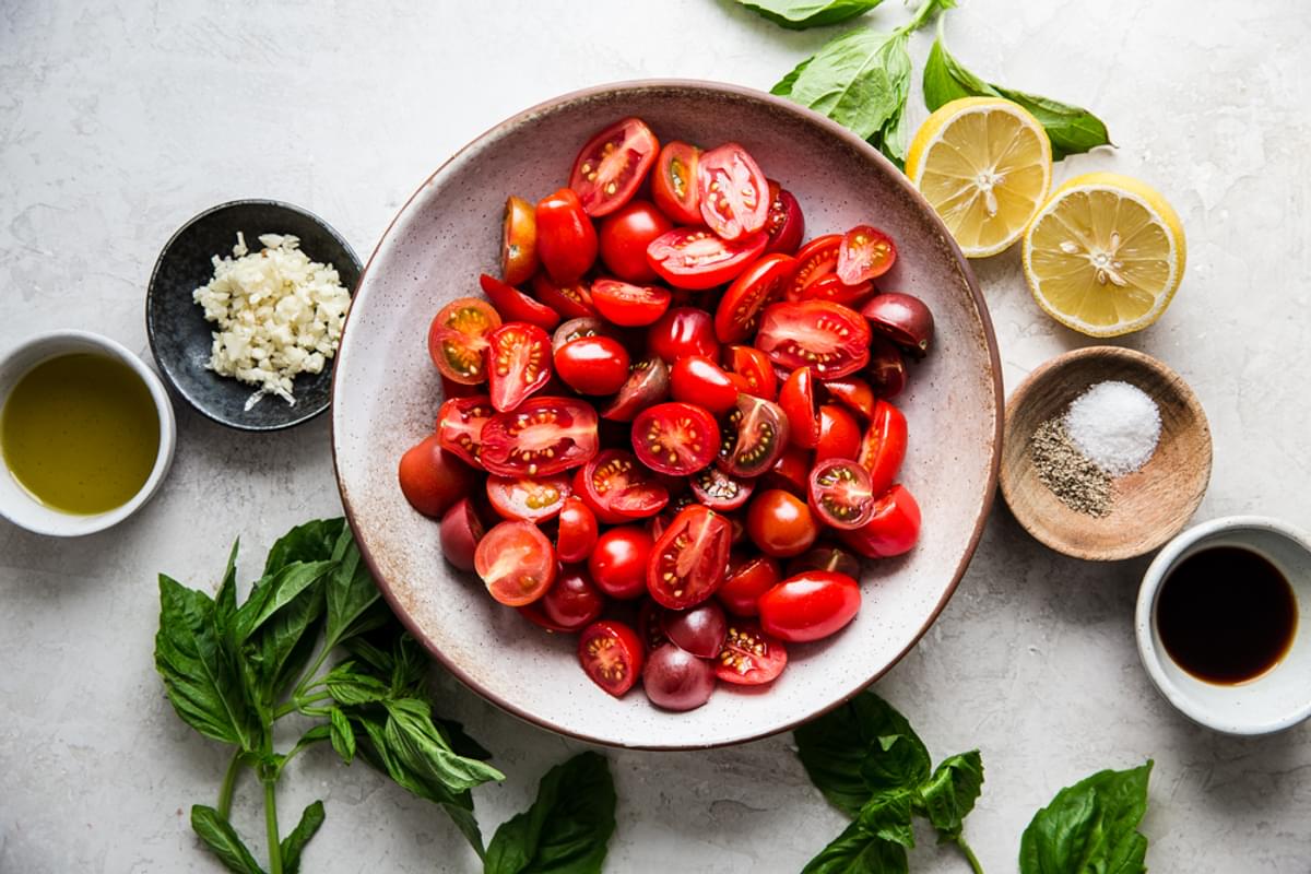 marinated tomato salad ingredients cherry tomatoes, balsamic, salt and garlic, lemon, basil, pepper and olive oil