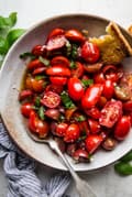 marinated tomato salad with basil in a bowl