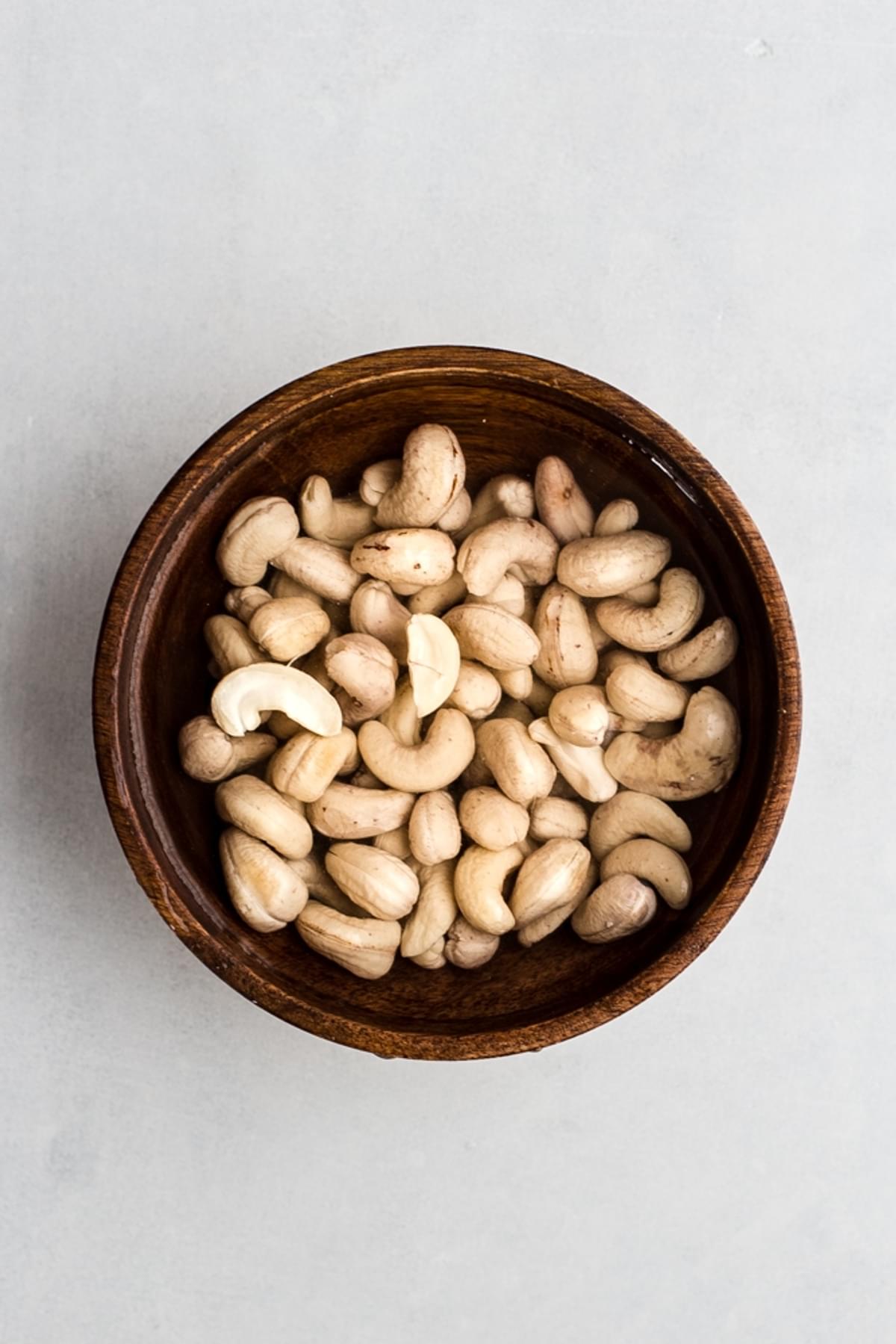 cashews soaking in a bowl of water