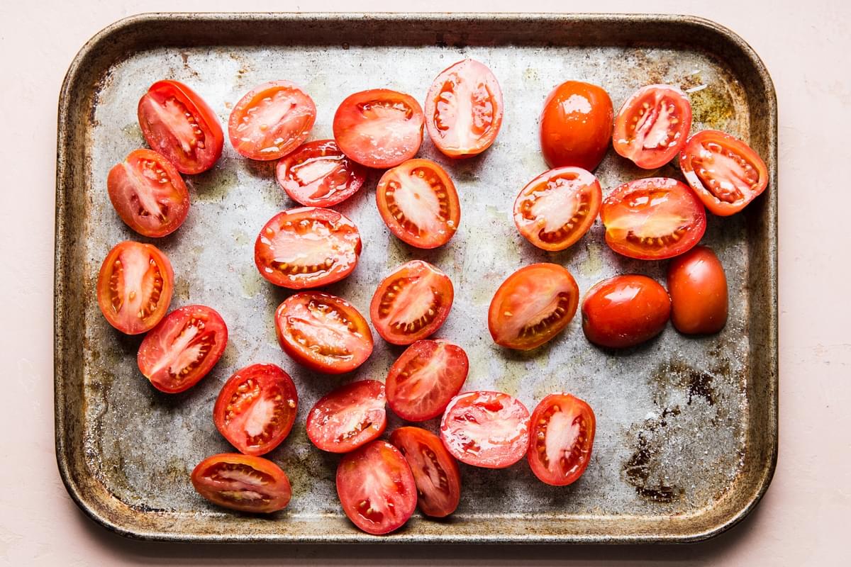 fresh tomatoes sliced on a sheet pan