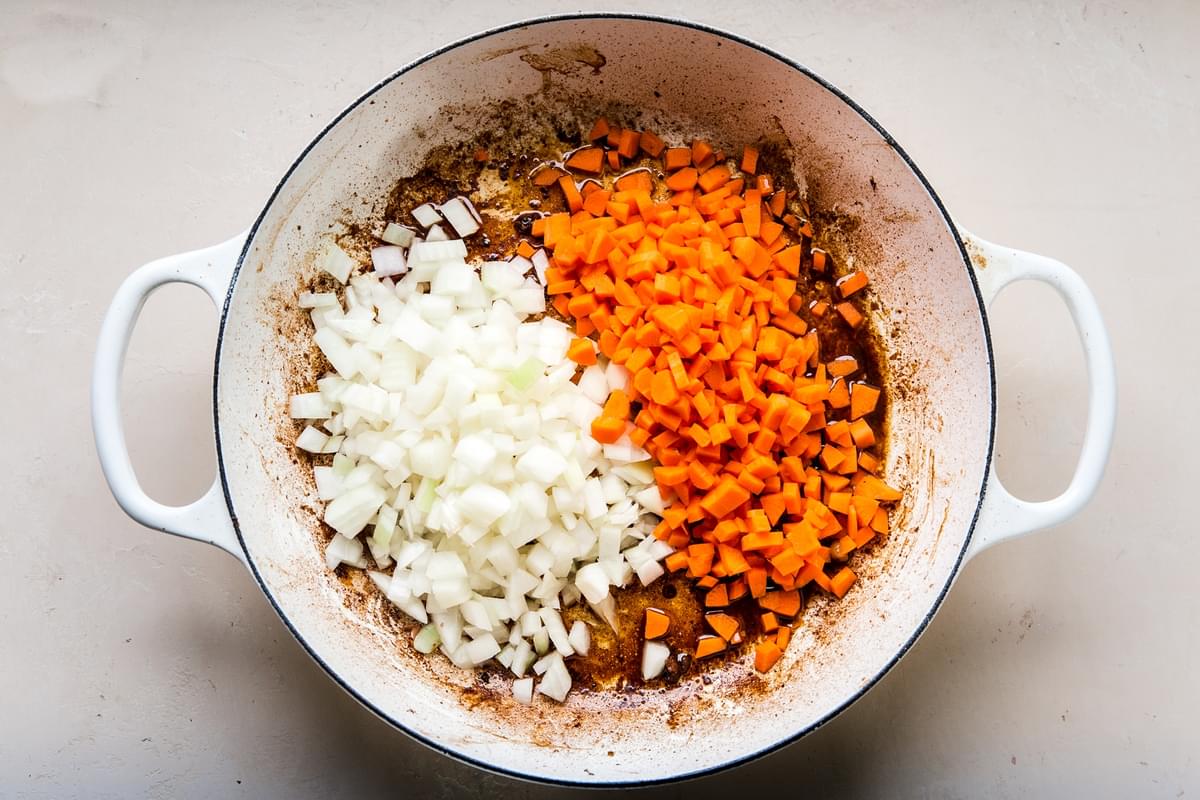 carrots and onions in a large braiser
