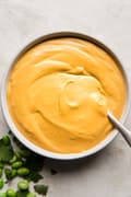 vegan cashew chipotle cream sauce in a bowl yumm sauce with a spoon