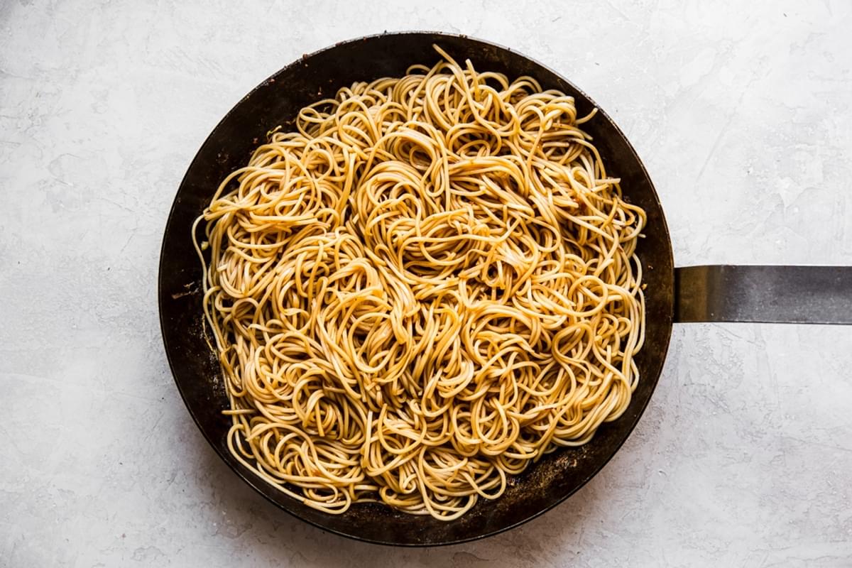 fresh chow mein noodles cooked in sauce in a large skillet