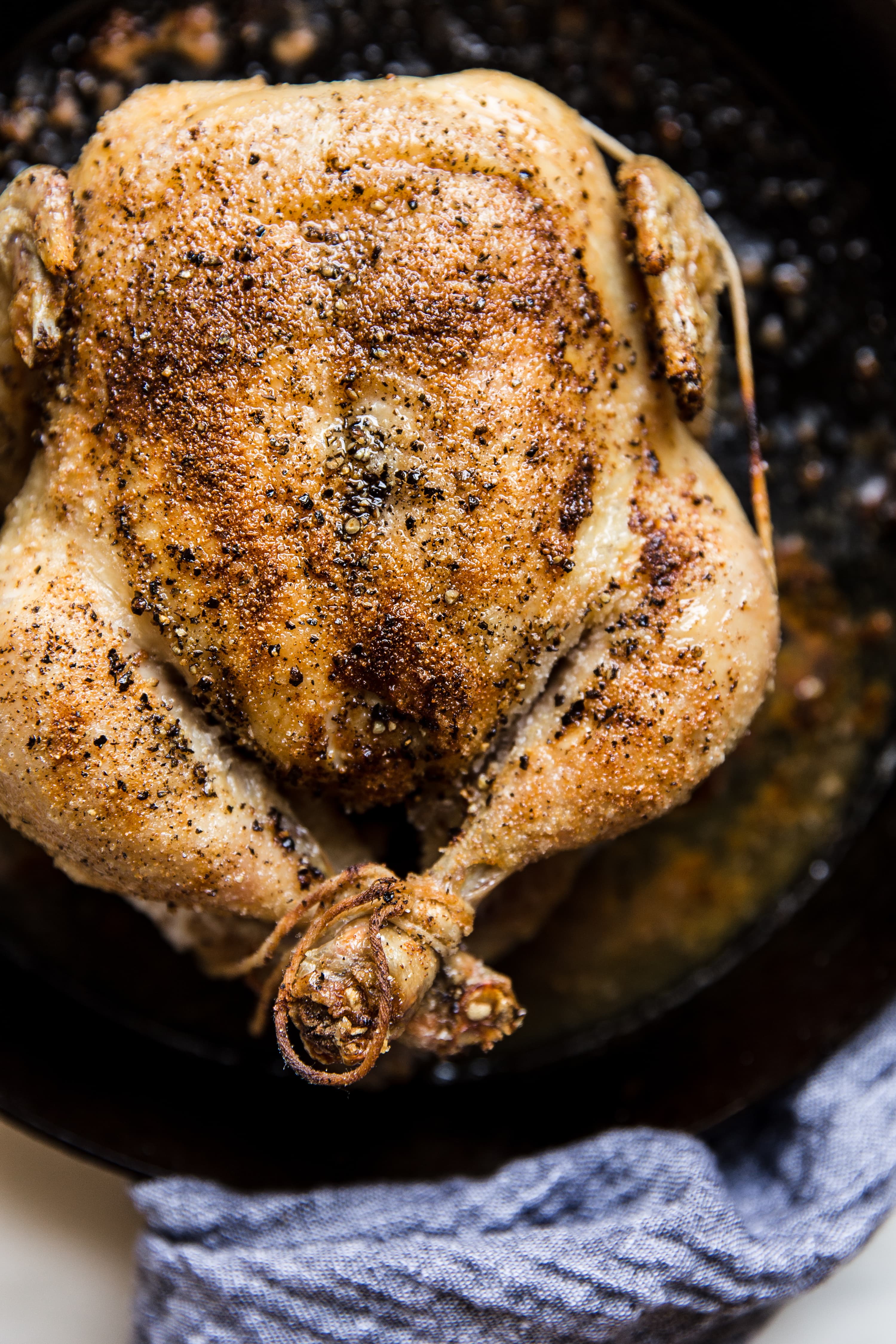 whole roasted chicken in a cast iron skillet