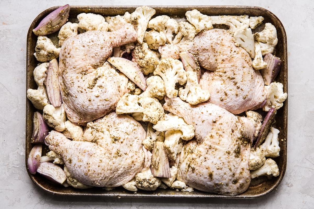 chicken, cauliflower and shallots on a sheet pan