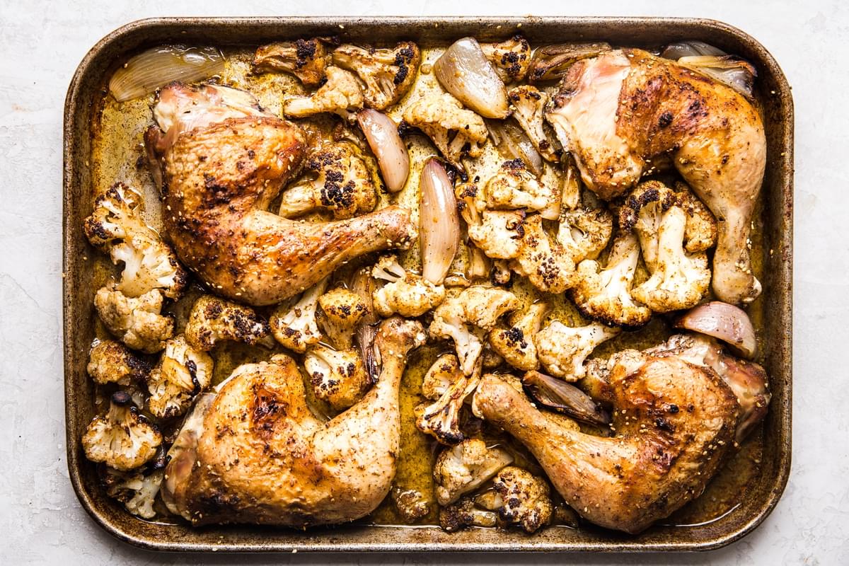 chicken roasted with cauliflower and shallots on a sheet pan