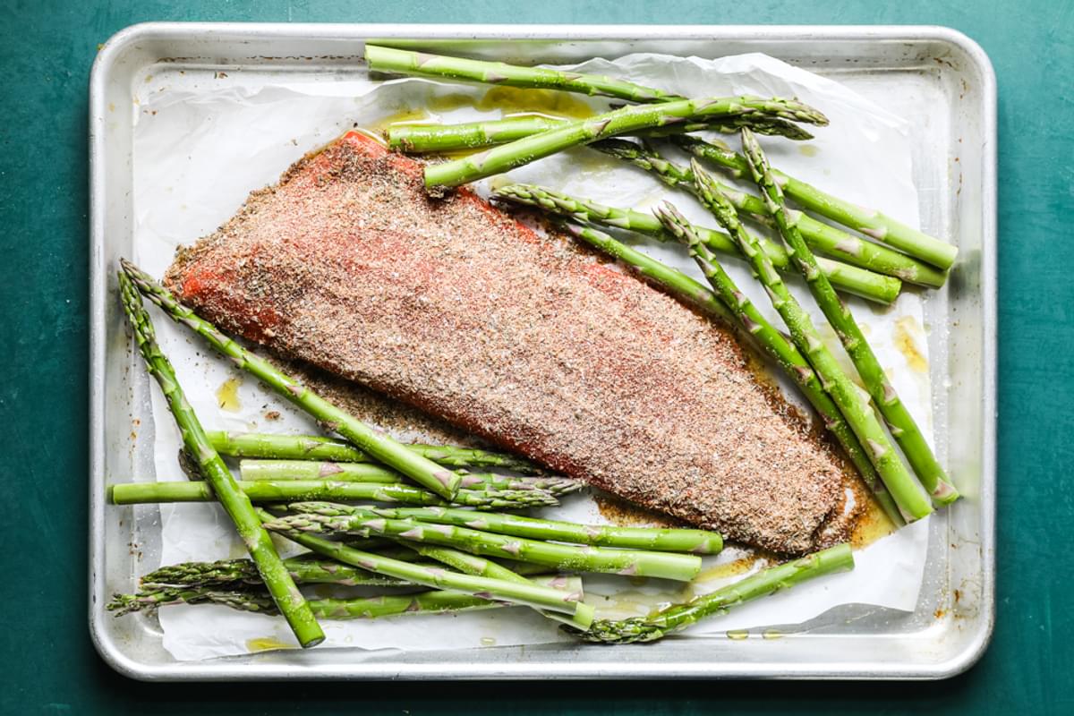 fillet of salmon with blackened seasoning and asparagus on a sheet pan