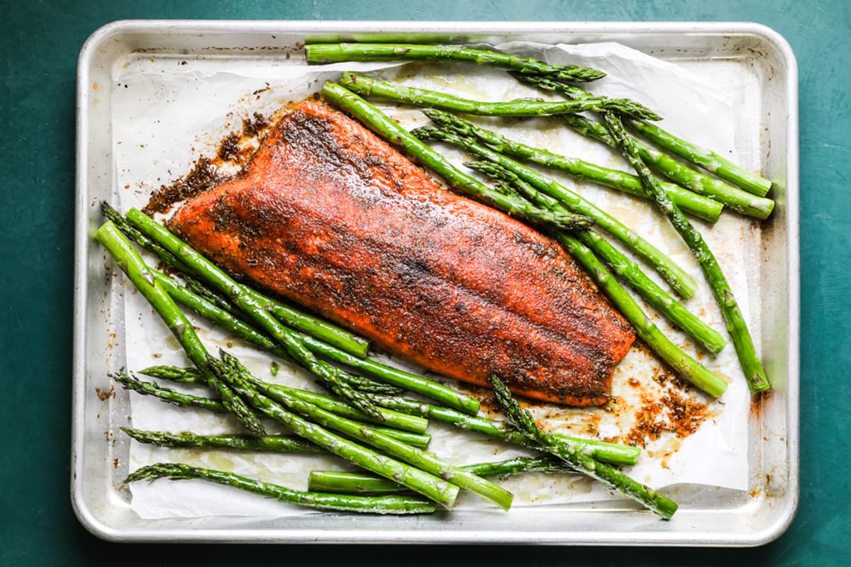 fillet of salmon with blackened seasoning and asparagus baked on a sheet pan