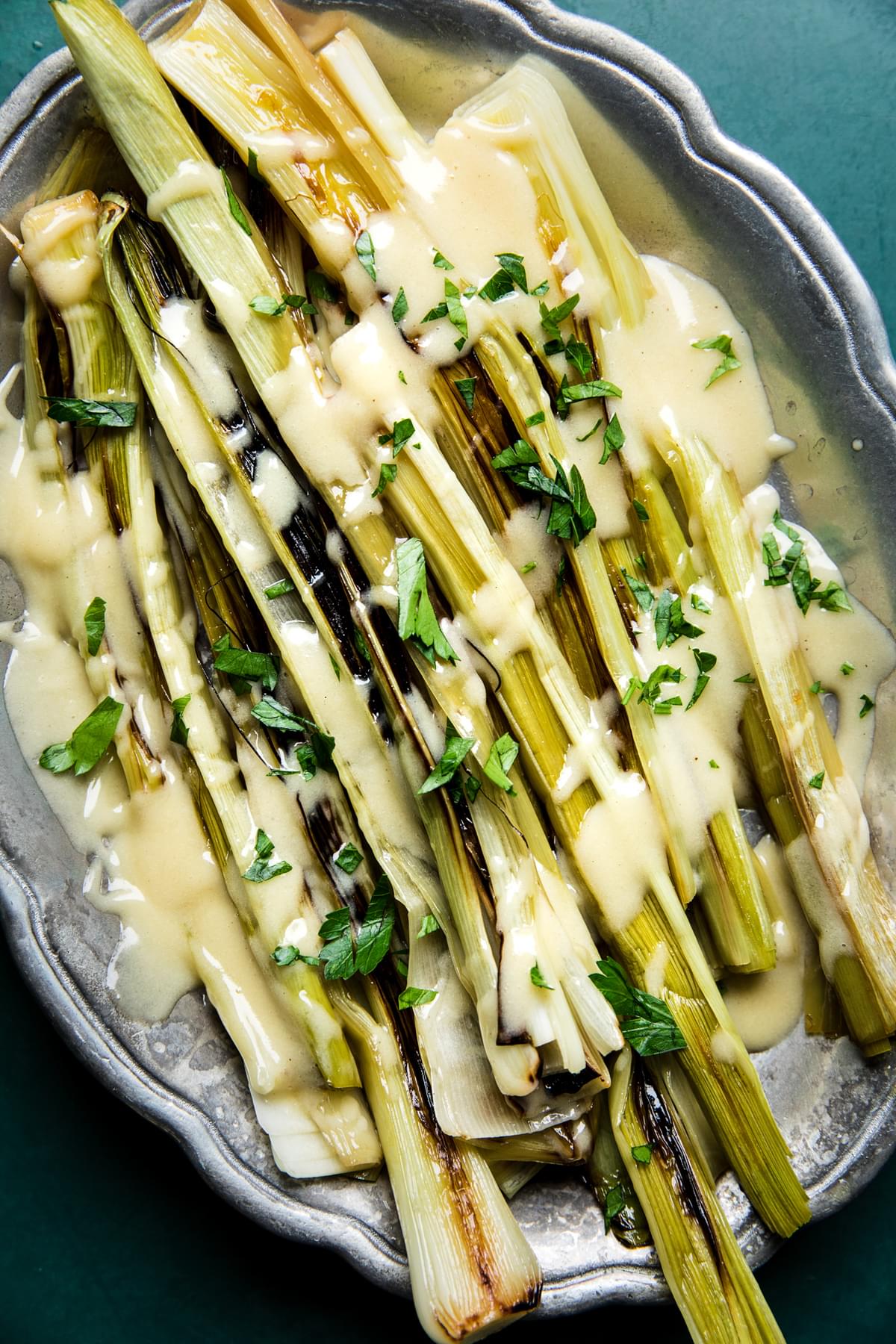 Braised Leeks with Beurre Blanc (French Butter Sauce) on a serving platter