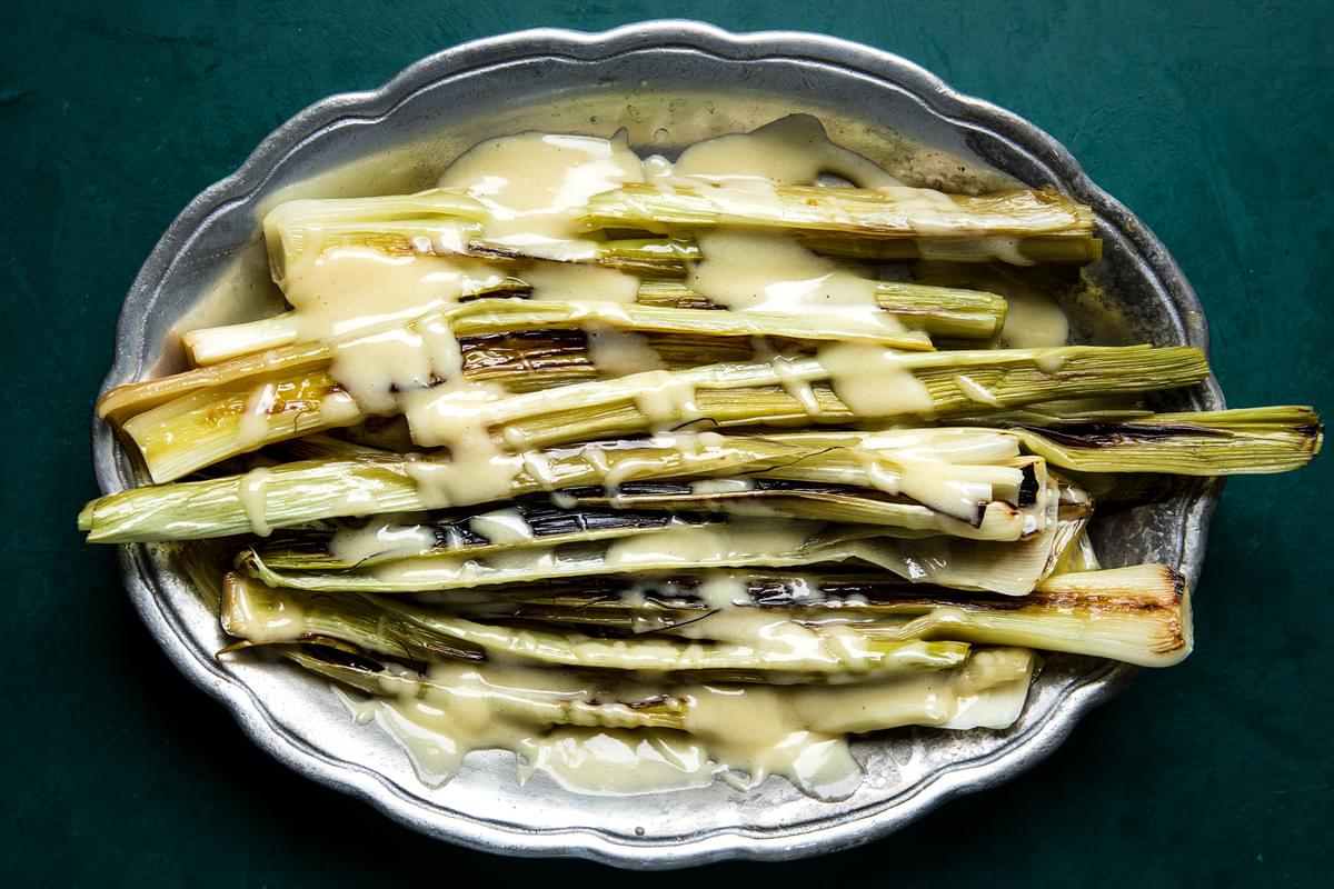 Braised Leeks with Beurre Blanc (French Butter Sauce) on a serving platter