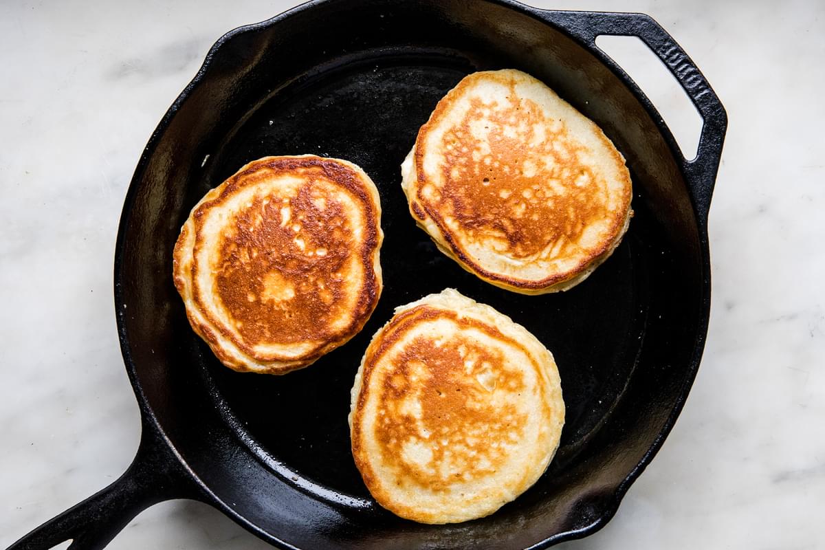 buttermilk pancakes being cooked in a skillet