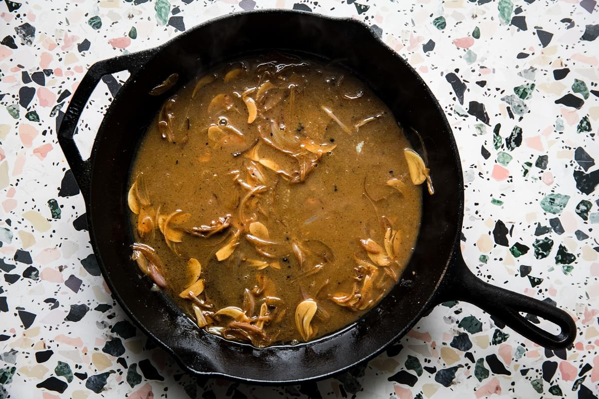 chicken pan sauce with butter and olive oil, garlic and shallots in a cast iron skillet