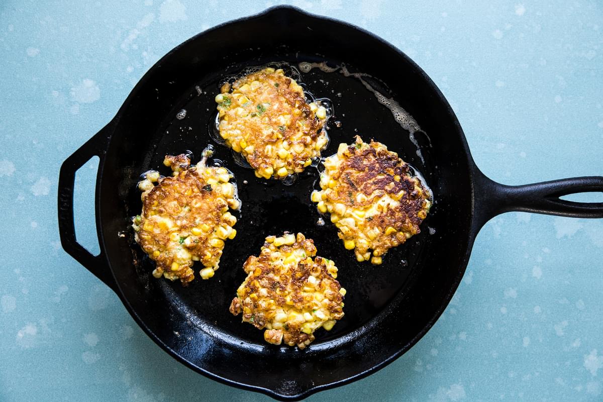 Homemade corn fritters in a cast iron pan