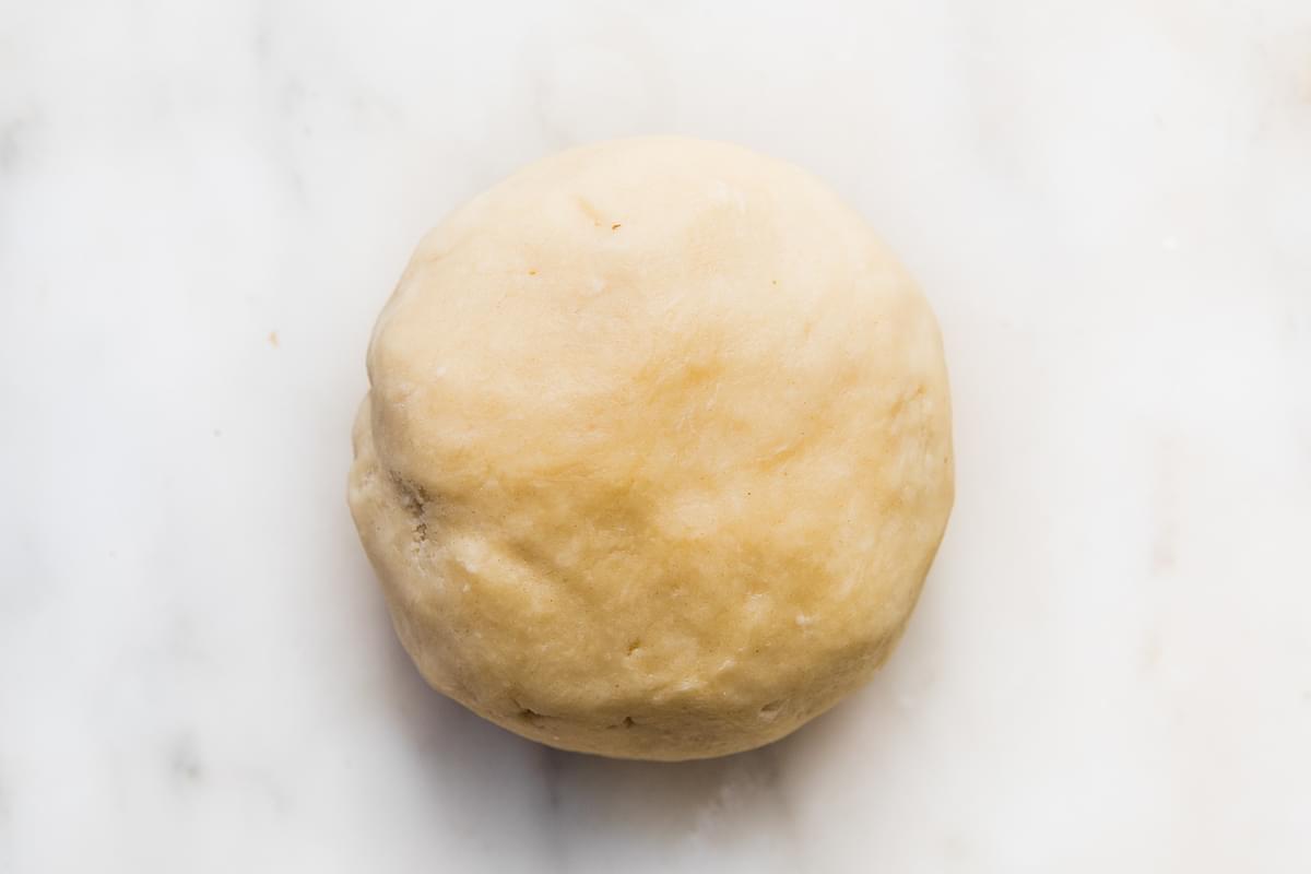 homemade easy all-butter pie crust dough in a ball on the counter