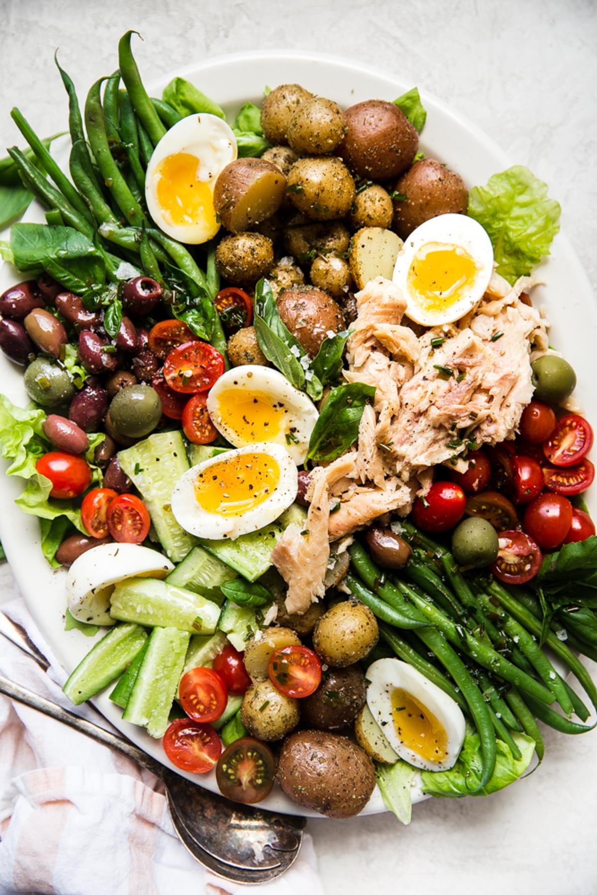 Easy Nicoise Salad made with eggs olives, and tomatoes