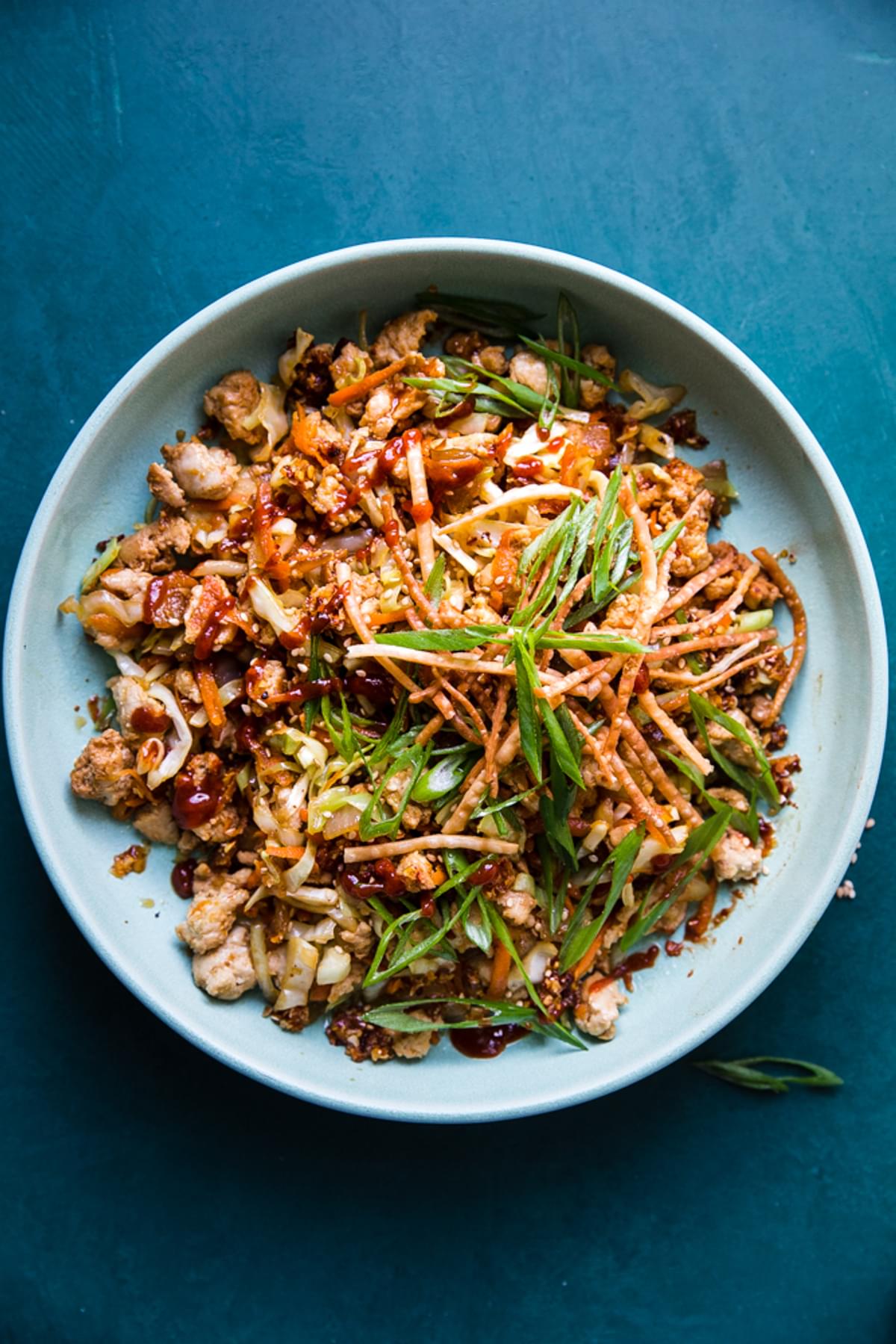 egg roll bowl with carrots, cabbage, ground turkey, green onions, chili paste and sesame