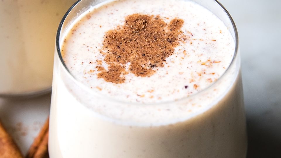 homemade eggnog in a glass with a dusting of nutmeg on top