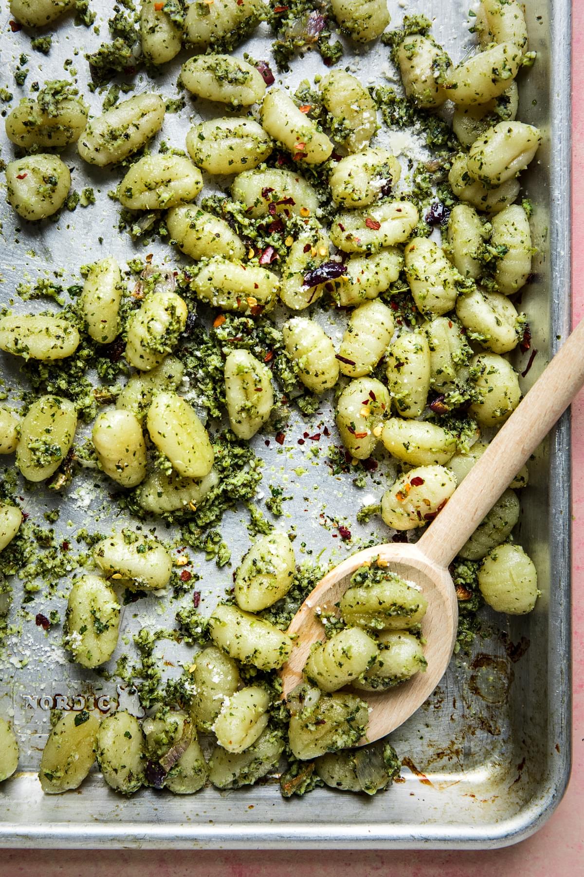 roasted broccoli pesto on a sheet pan with a wooden spoon