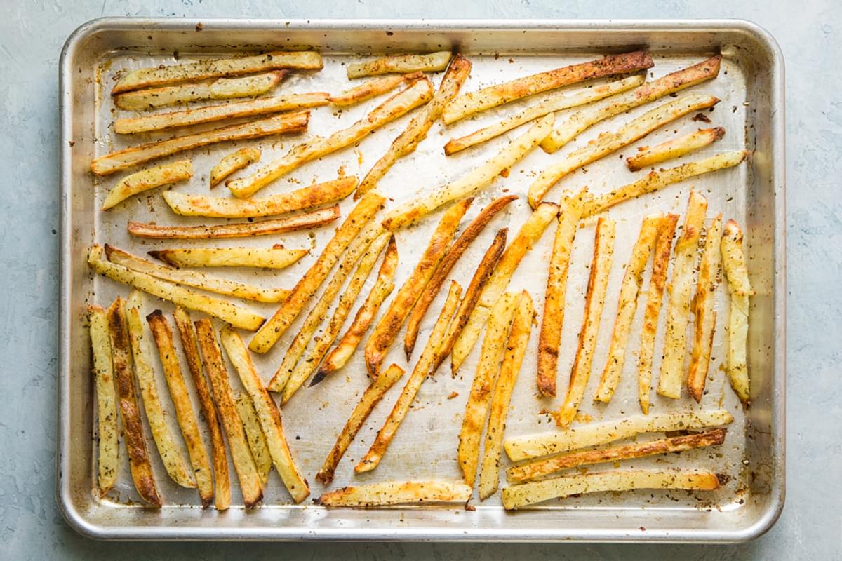 baked greek french fries on a baking sheet
