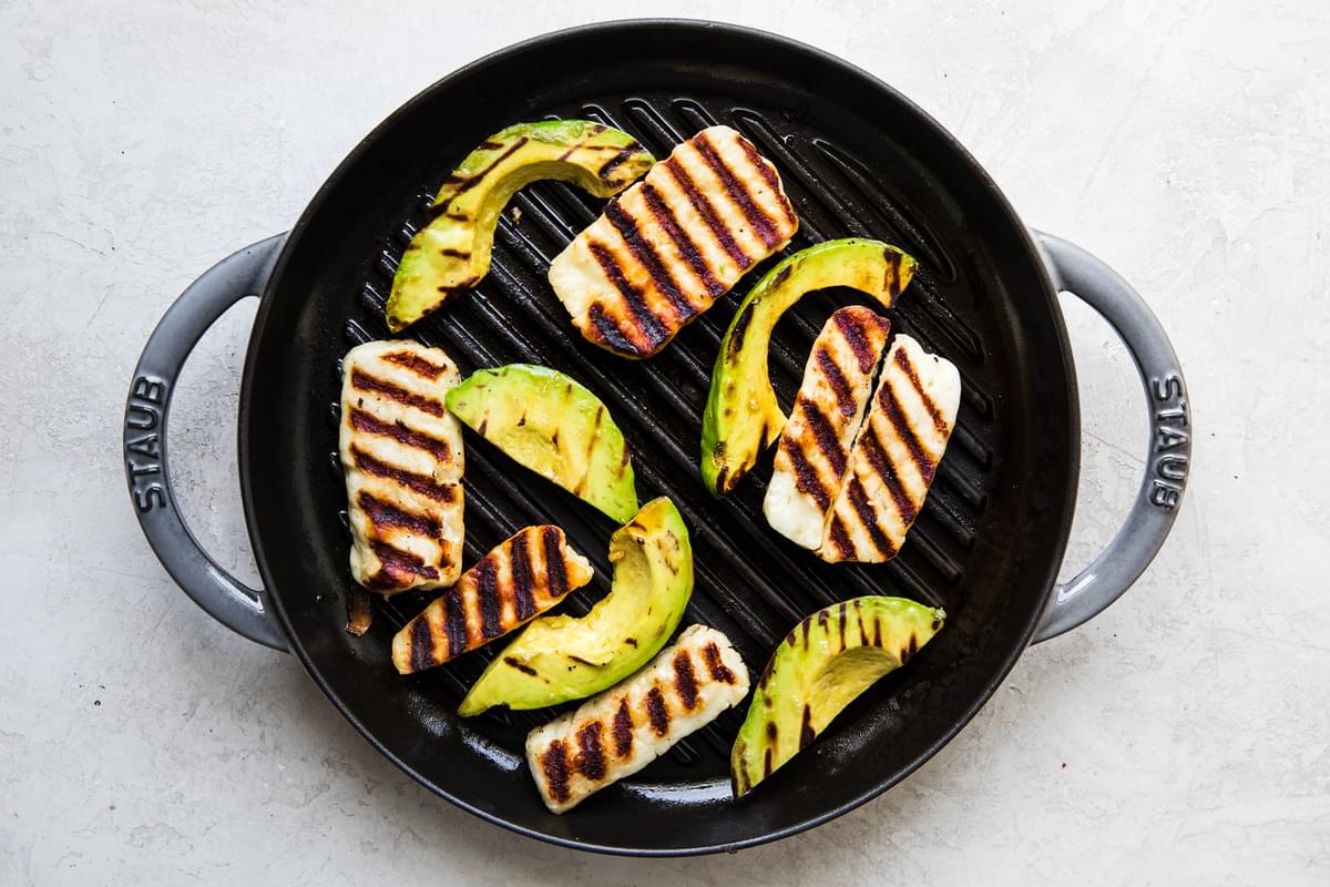 Grilled halloumi and grilled avocado on a grill pan
