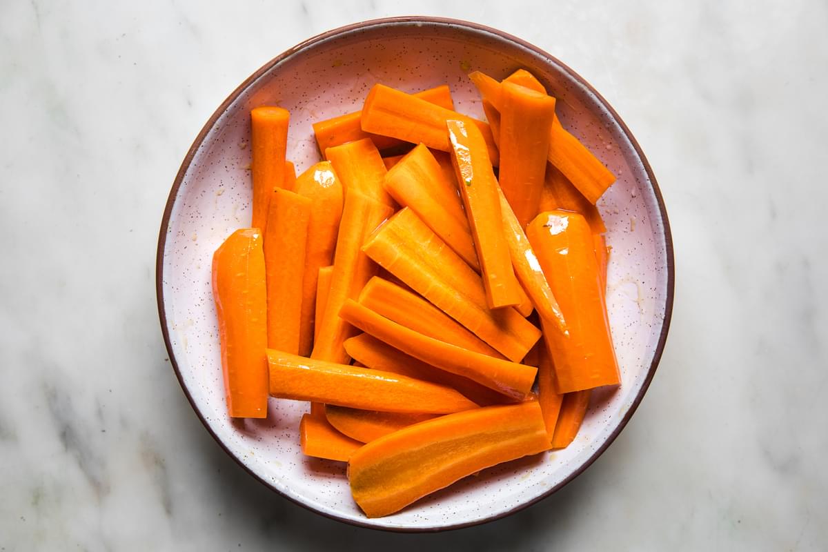 carrots with olive oil and salt in a bowl
