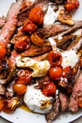 grilled skirt steak with blistered tomatoes and burrata