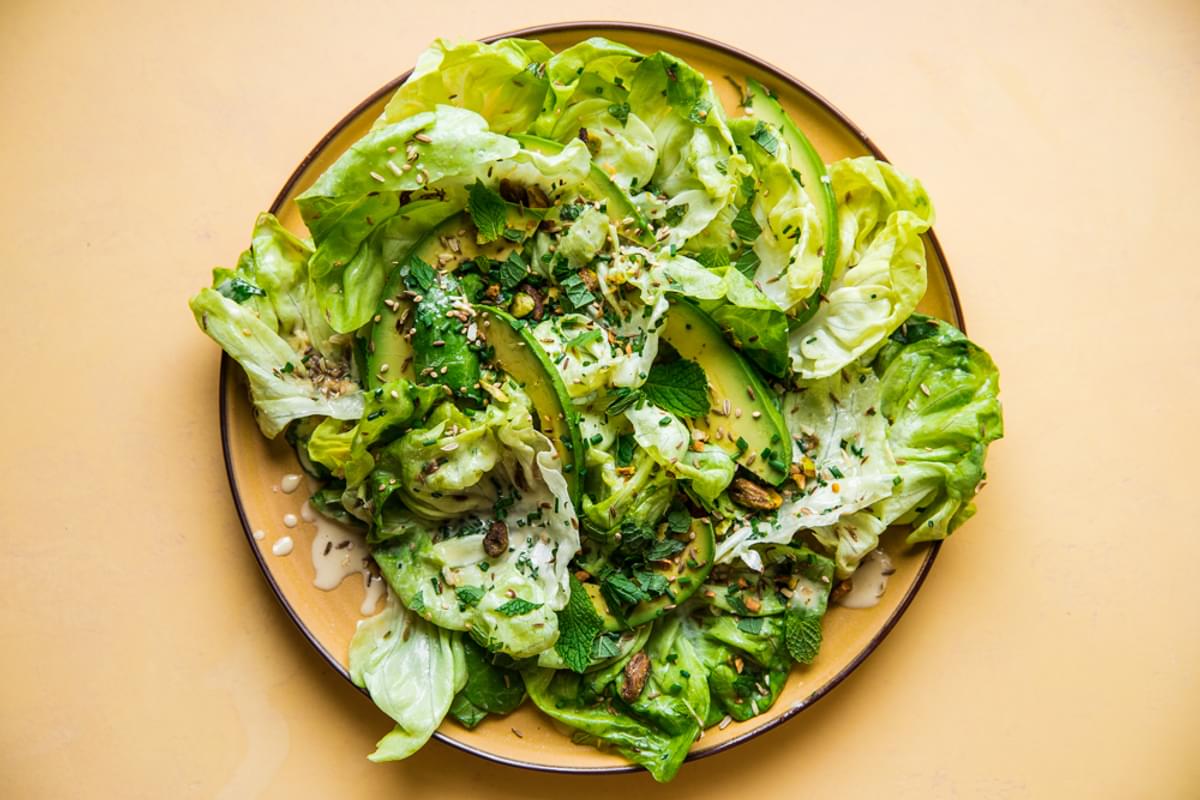 Herby Seedy Butter Lettuce Salad with Tahini Dressing on a plate