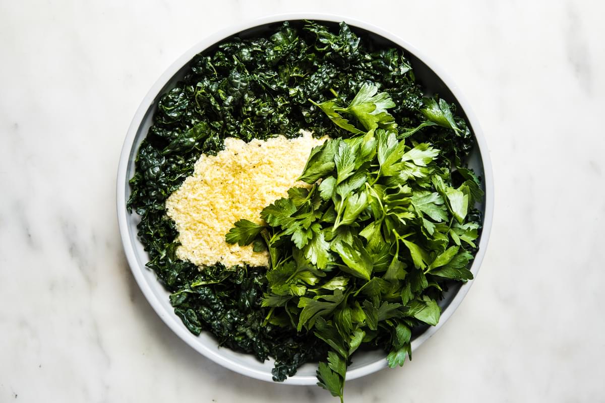 Kale Salad with Lemon Parmesan Dressing, parsley in a bowl