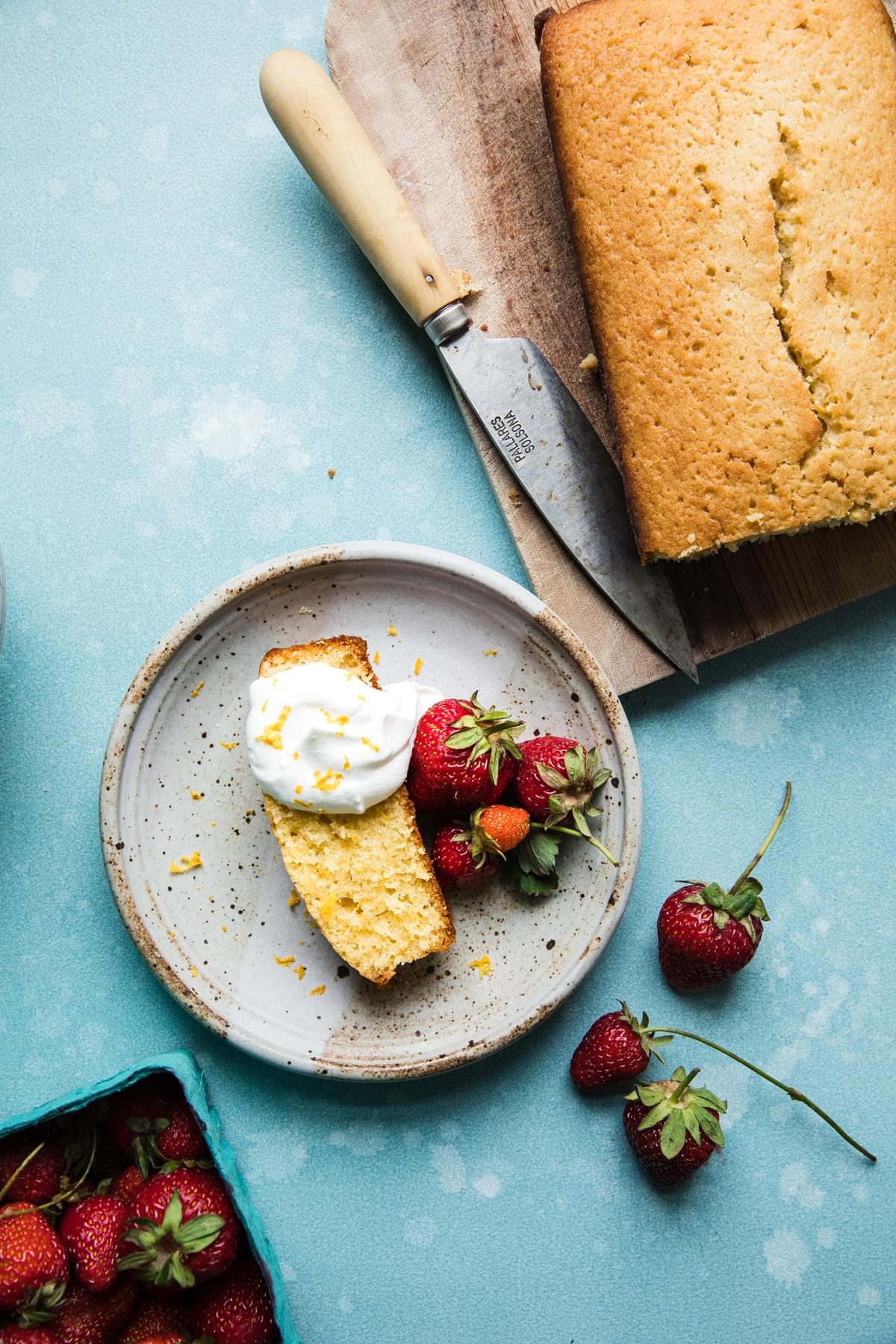 lemon olive oil pound cake with fresh berries and whipped cream,