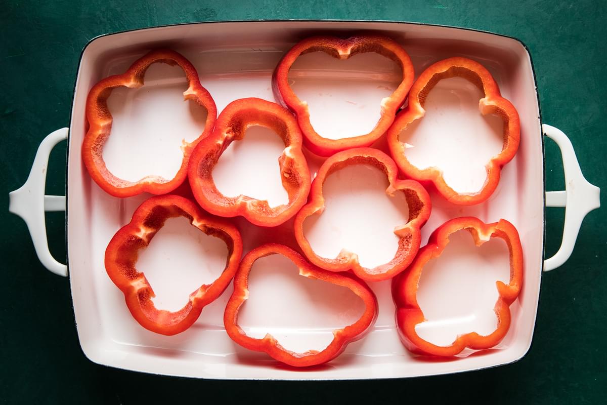 bell pepper rings in a 9x13 baking dish on the counter
