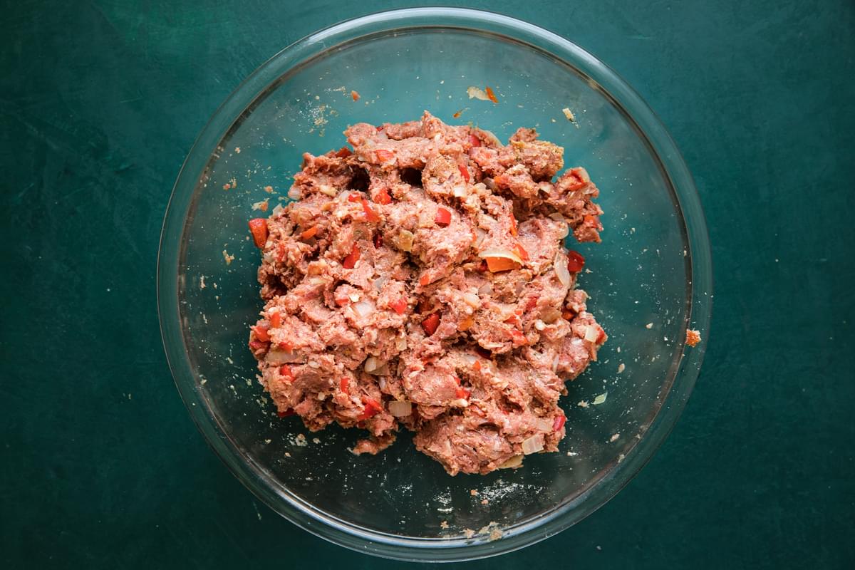 ground beef, ground sausage, bread crumbs, mixed together in a bowl