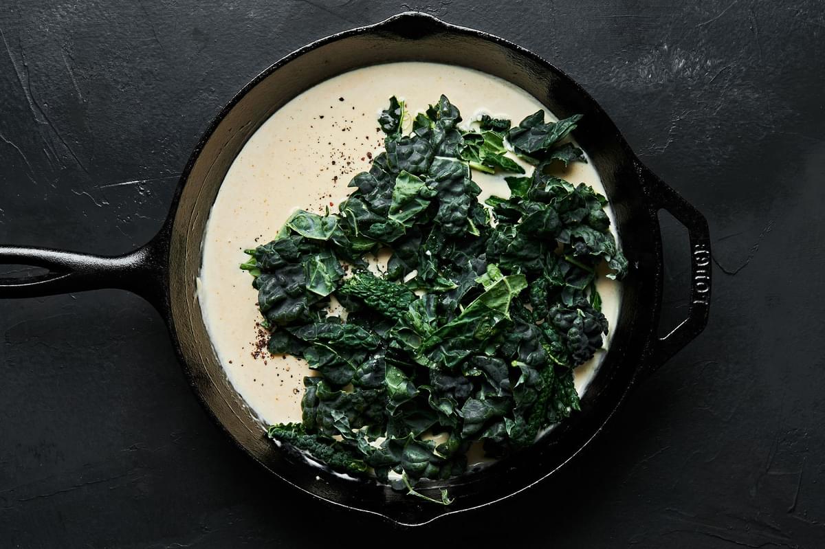 cream sauce with kale a cast iron skillet
