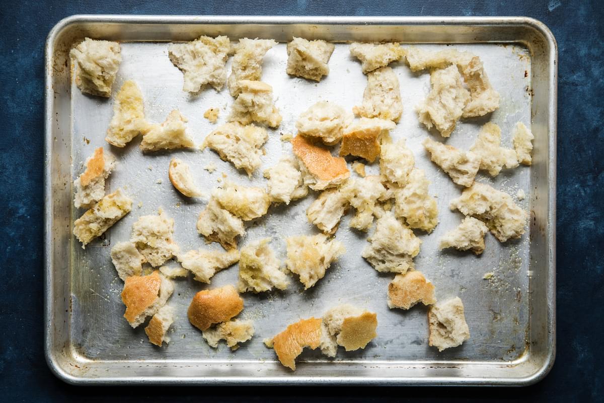 torn pieces of bread on a baking sheet