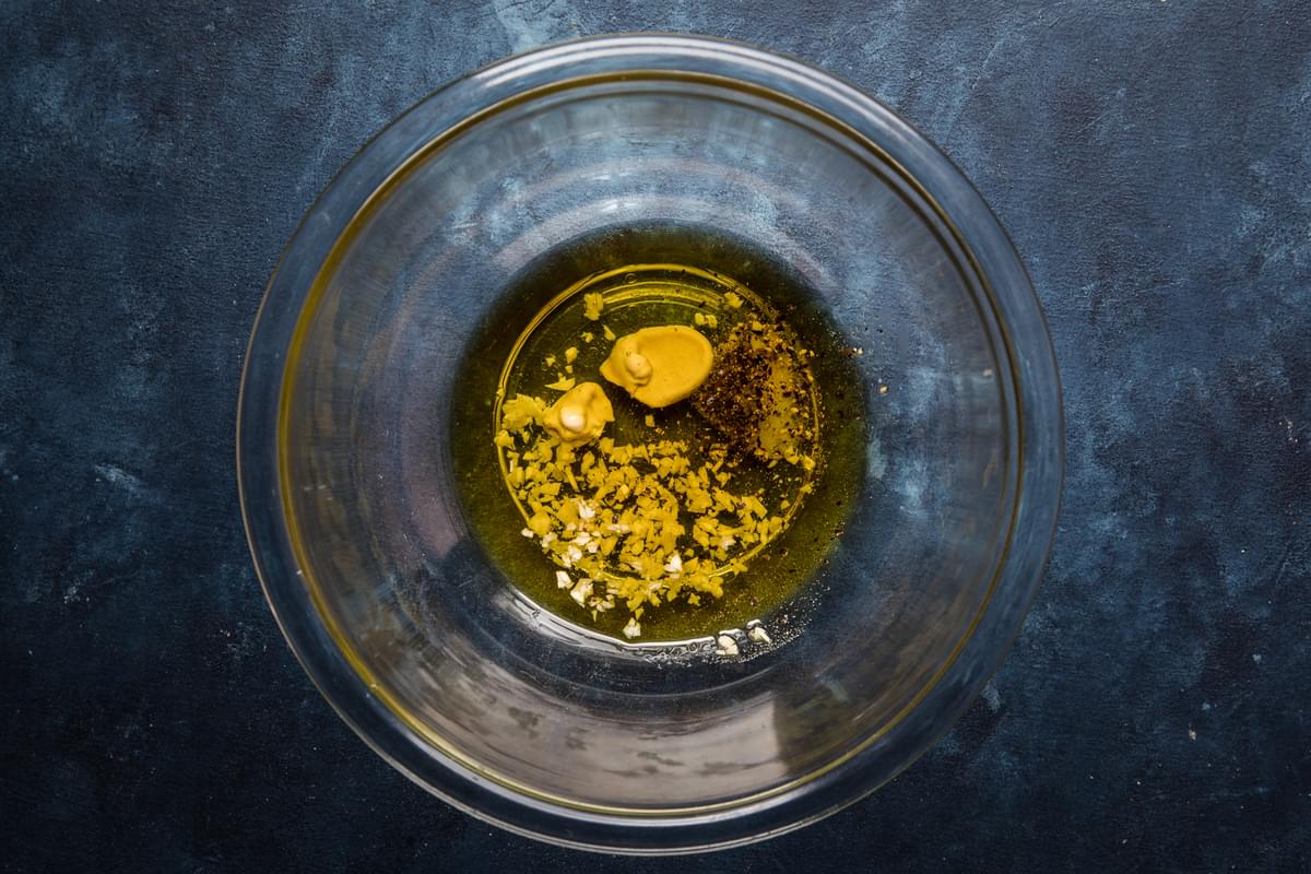 dijon, olive oil, balsamic, onions, sugar and salt in a bowl for vinaigrette