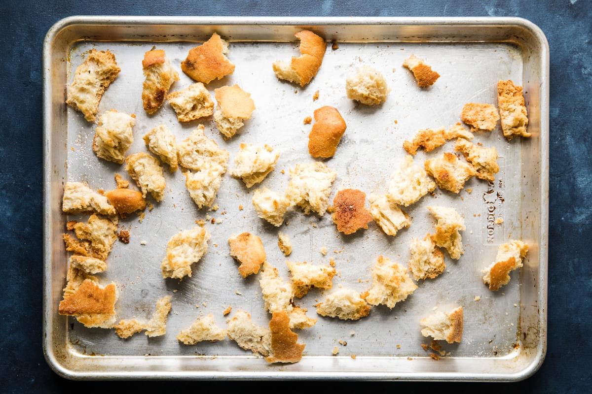 torn pieces of bread baked until golden on a baking sheet