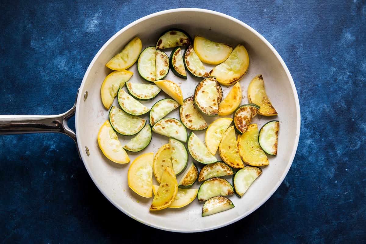 zucchini and summer squash cooked in a pan