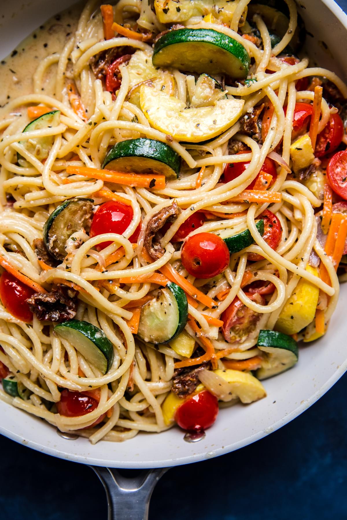 homemade pasta primavera with zucchini, carrots, tomatoes in a creamy parmesan sauce