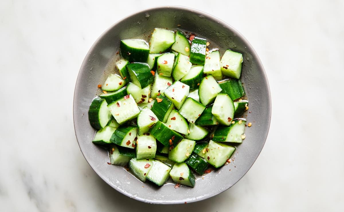 cucumbers marinated in rice vinegar, sugar, salt, red pepper flakes and sesame oil in a bowl for poke