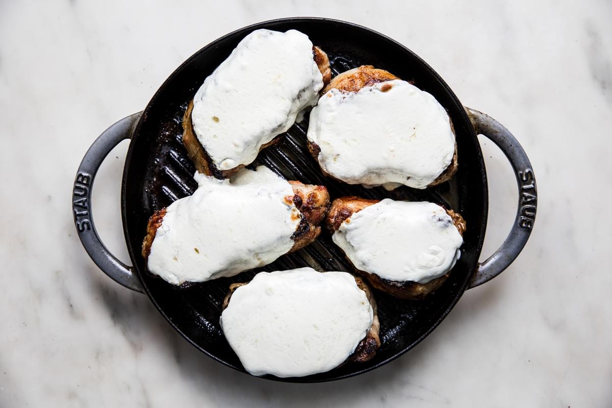 grilled pork chops topped with fresh mozzarella slices
