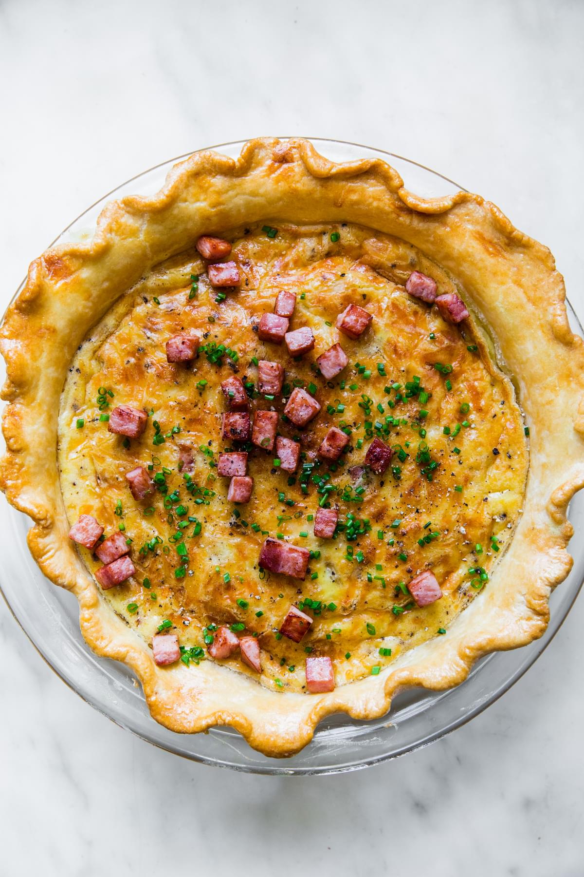 homemade quiche Lorraine topped with diced ham