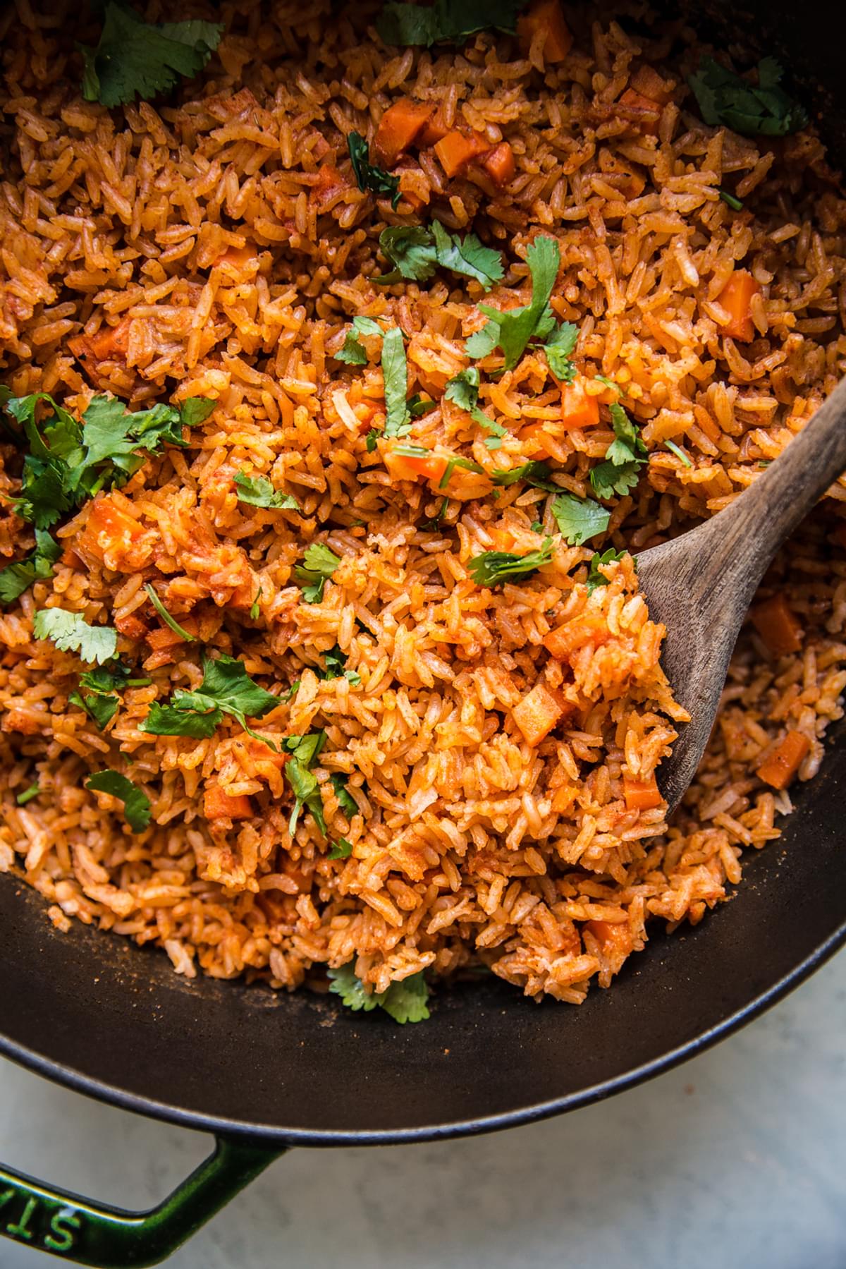 A large pot of mexican-style rice in a pot topped with cilantro