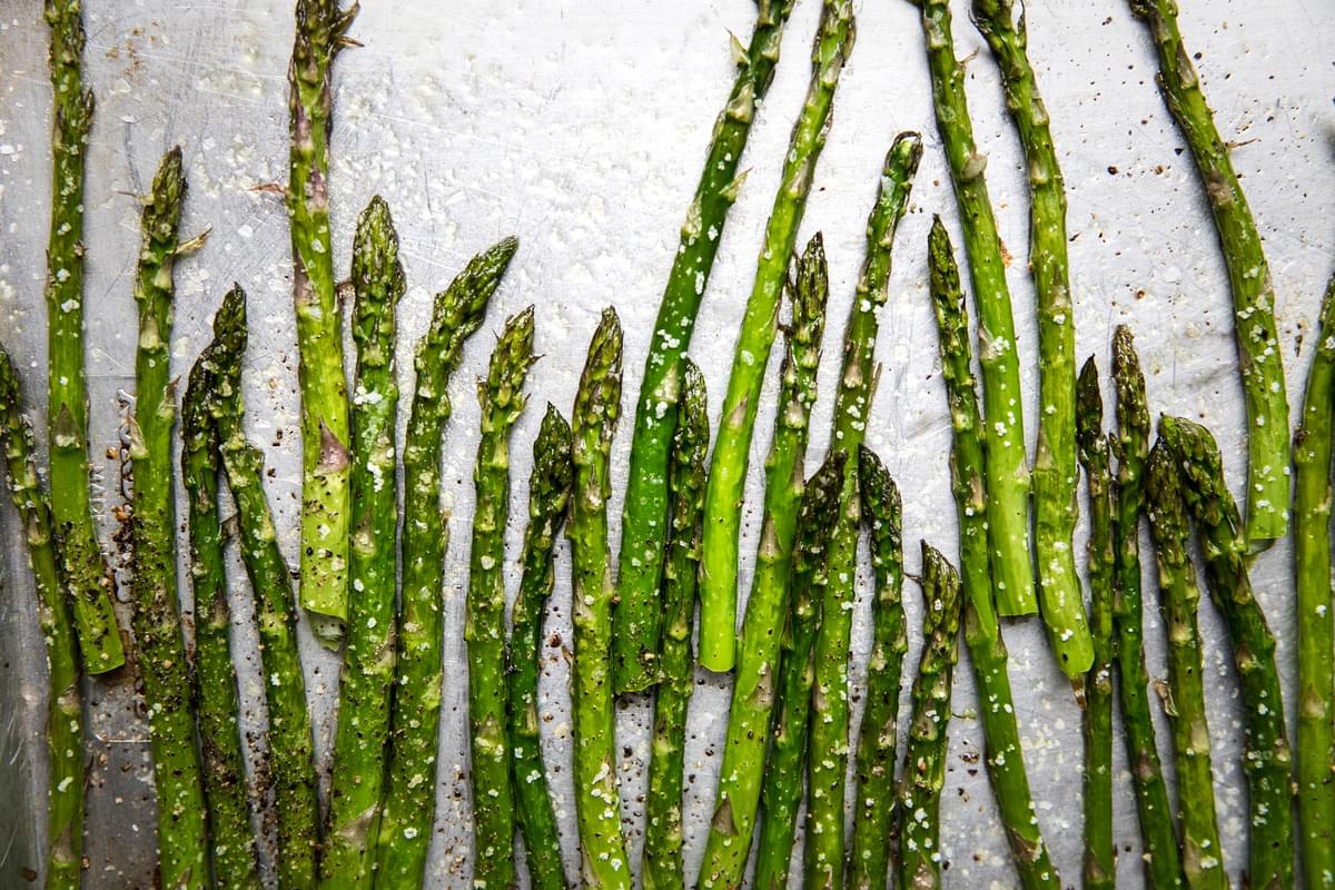 roasted asparagus with olive oil, salt and pepper on a baking sheet