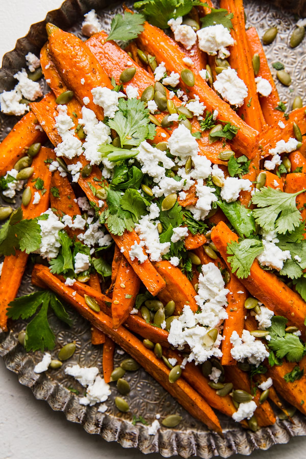 Za’atar Roasted Carrots with Feta and Pumpkin Seeds on a serving tray