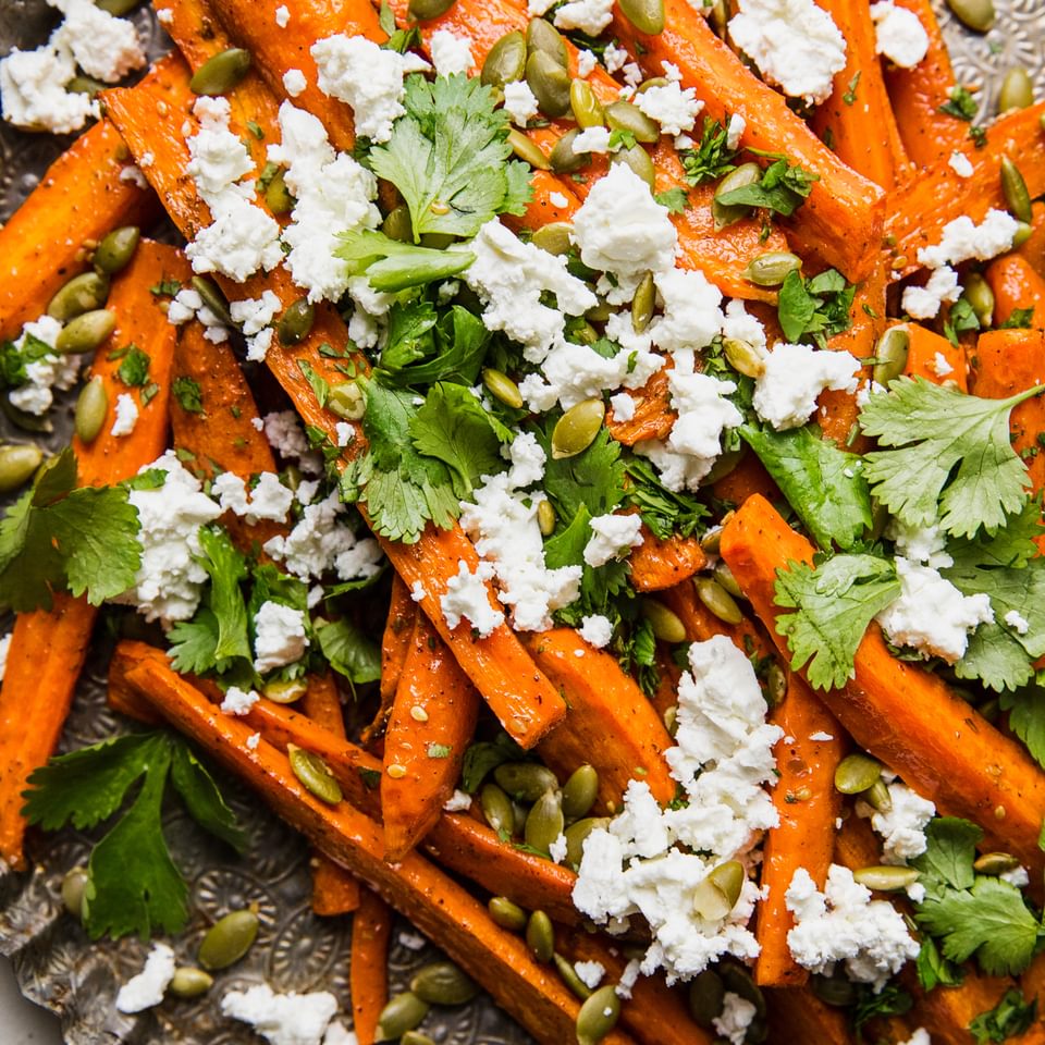 Za’atar Roasted Carrots with Feta and Pumpkin Seeds on a serving tray