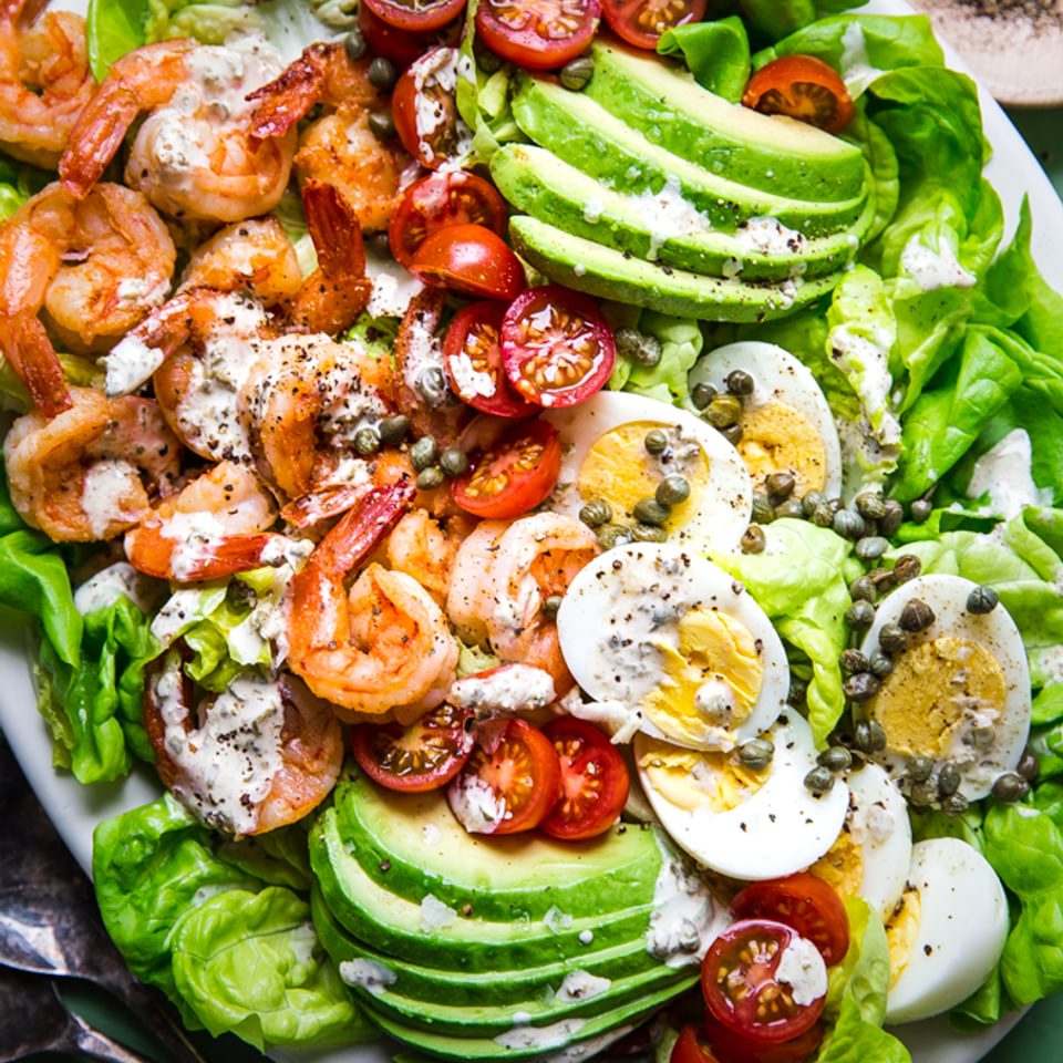 homemade shrimp louie salad with avocado, hard boiled eggs, tomatoes and capers with a tangy dressing