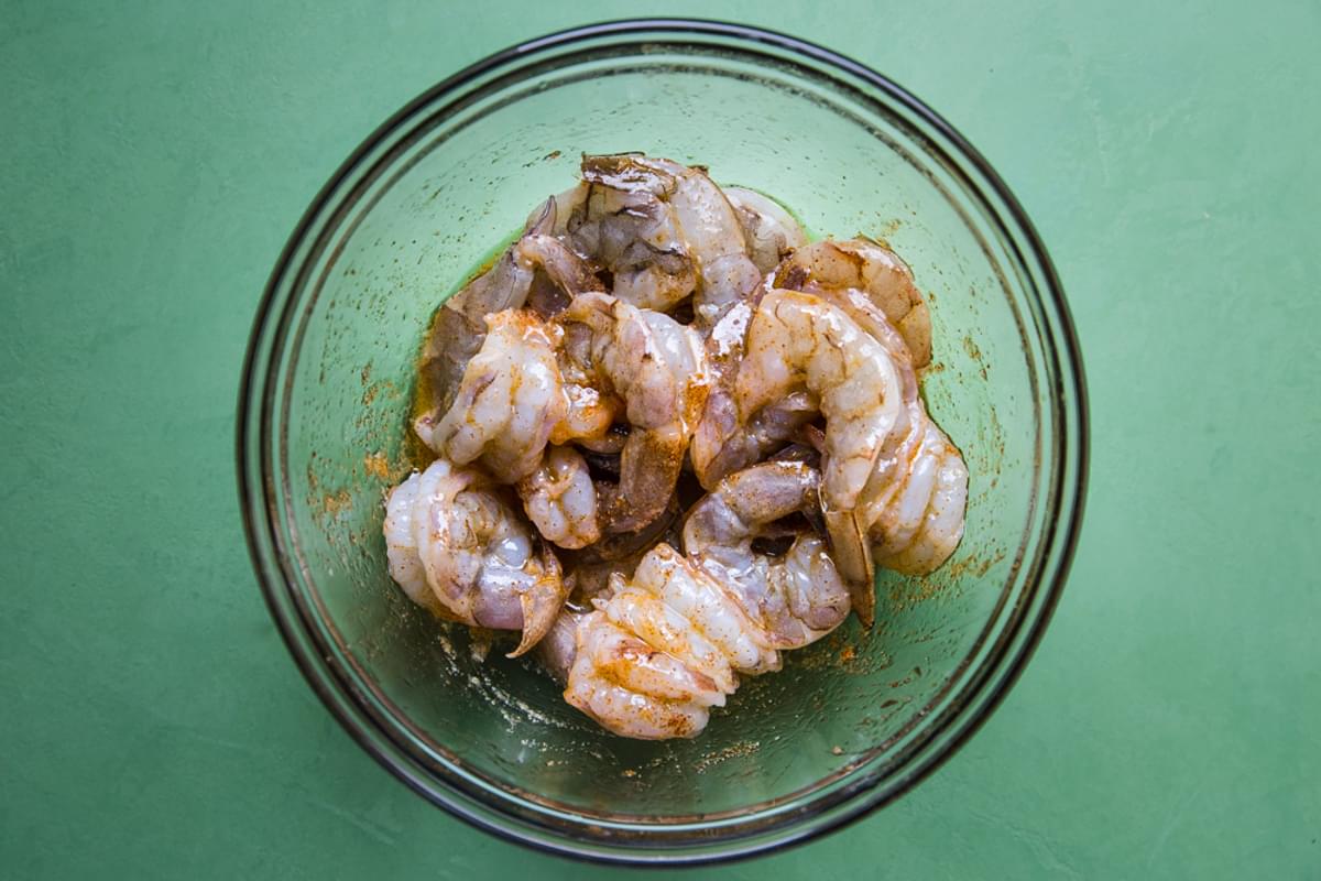 raw shrimp marinated in spices in a bowl